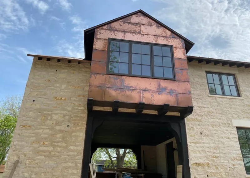 Copper metal panel facade on a stone building for Metal Roof Coating in Bagley