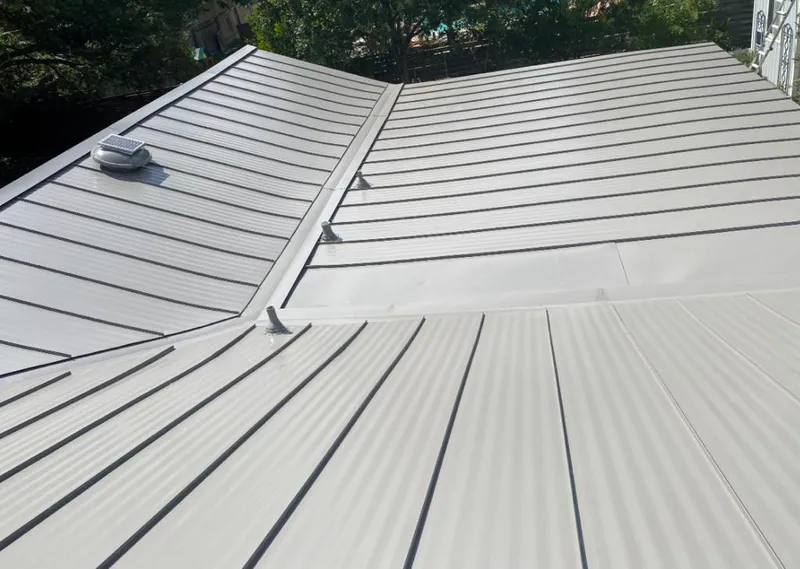 Solar attic fan installed on a metal roof for Roof Ventilation in Bagley